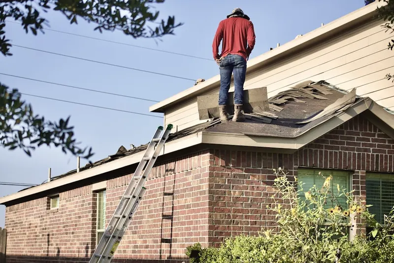 Professional roofer working on a residential roof in The Reserve